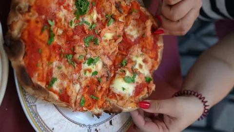 Vertical closeup cropped shot of unrecognizable woman taking slice being cut Stock Footage 253597237