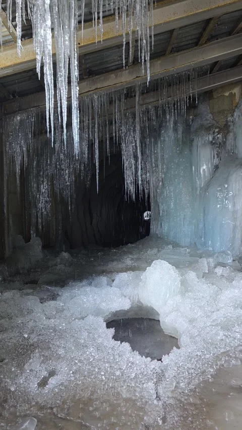 Vertical Closeup Details View of Icicles and Ice Build Up in Frozen Tunnel Video stock 343009733