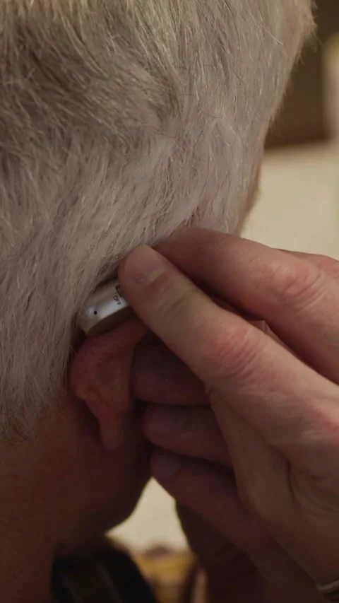Vertical Closeup of Elderly Man Putting On Hearing Aid Stock Footage 323927724