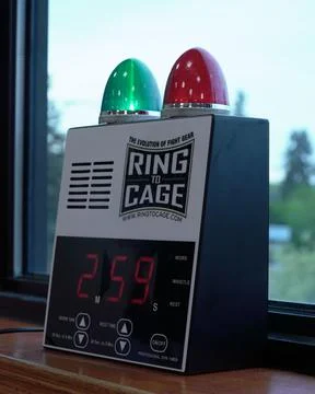 Vertical closeup of an electronic boxing bell with a countdown timer on a window 写真素材