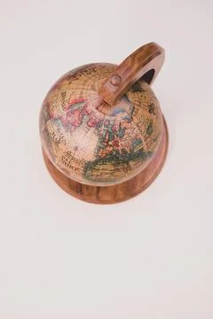 Vertical closeup of a globe model on an aesthetic cream background. Foto stock