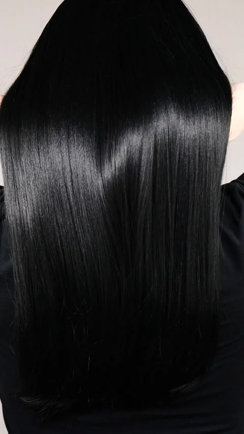 Vertical closeup of human female long black straight hair texture in slow motion Stock Footage 279052013