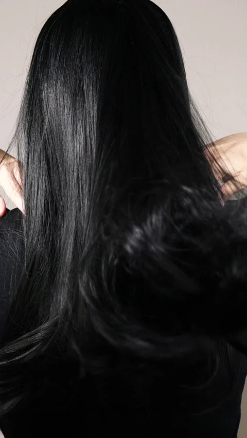 Vertical closeup of human female long black straight hair texture in slow motion Stock Footage 280100993
