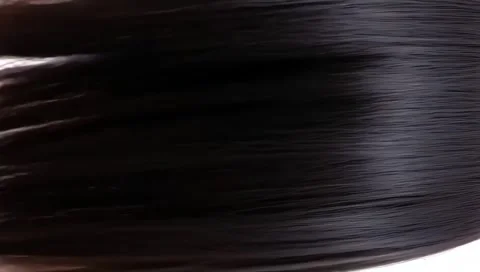 Vertical closeup of human female long black straight hair texture in slow motion Stock Footage 300014740