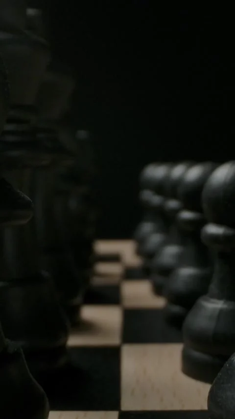 Vertical of A closeup look at a chessboard with black pieces strategically Stock Footage 276927531