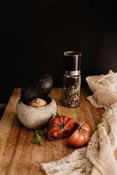 Vertical closeup of a messy table with smashed vegetables and pepper spilled all Stock Photos