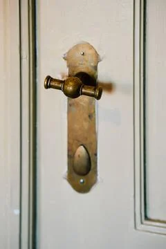 Vertical closeup of an old and rustic door knob 스톡 사진