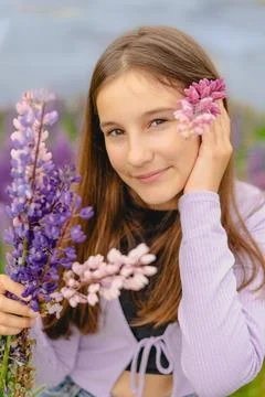 Vertical closeup portrait little attractive girl smiling and holding bouque.. Foto stock