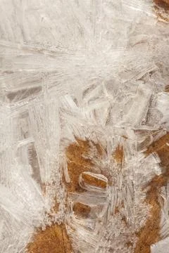 Vertical closeup shot of ice formations on the stream Stock Photos