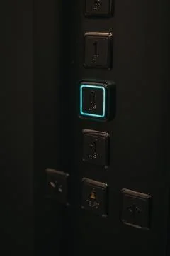 Vertical closeup shot of an illuminated elevator button Foto stock