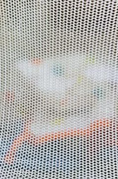 Vertical closeup shot of a mesh surface with a blurred background Stock Photos
