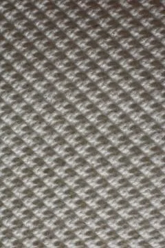 Vertical closeup shot of a patterned rough surface 스톡 사진