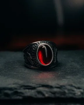 Vertical closeup of the silver ring with a big red stone. Stock Photos