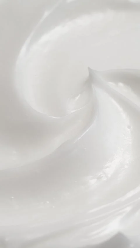 Vertical closeup white eye, skin cream texture background, facial cosmetics mask Stock Footage 313103840