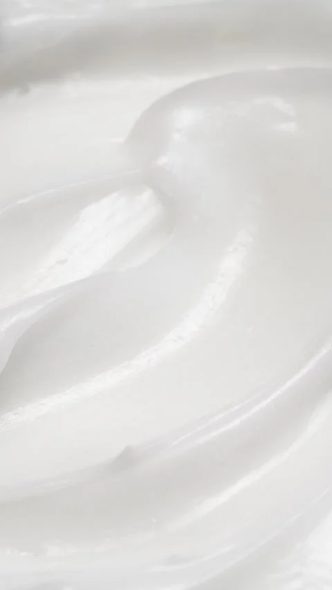 Vertical closeup white eye, skin cream texture background, facial cosmetics mask Stock Footage 313515802