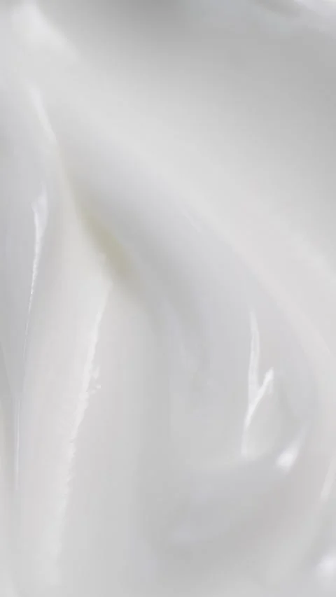 Vertical closeup white eye, skin cream texture background, facial cosmetics mask Stock Footage 327199452