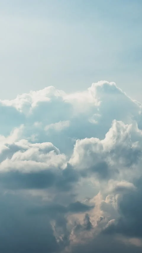 Vertical clouds drifting across blue sky creating calm atmospheric background. Stock Footage 330604735