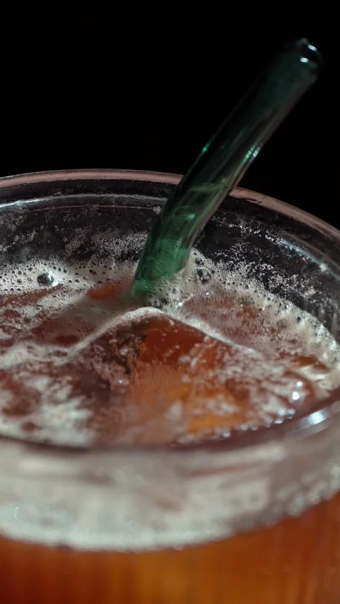 Vertical Coffee Tonic Hand Stirring Ice Glass Straw Dark 4K Stock Footage 325344460