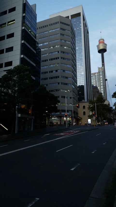 Vertical Commuters through the city with Sydney Observation Tower in backg Stock Footage 305608742