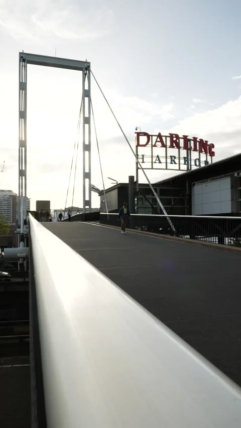 Vertical commutors cross the bridge to Darling Harbour in Sydney 6K Stock Footage 306633985