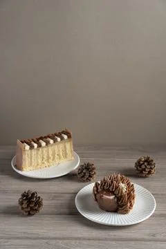 Vertical composition with cute hedgehog cupcake and layered cake slice Stock Photos