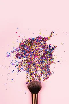 Vertical composition with professional cosmetic makeup brush with explosion of Stock Photos