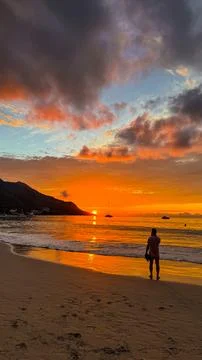 Vertical Composition of Sun Setting Behind Mountain, Casting Warm Glow Stock Photos