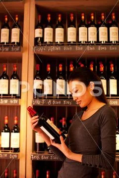Vertical composition Watch Wine shop Wine bottle Retail Price tag Women Shelf Stock Photos