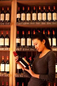 Vertical composition Watch Wine shop Wine bottle Retail Price tag Women Shelf Stock Photos