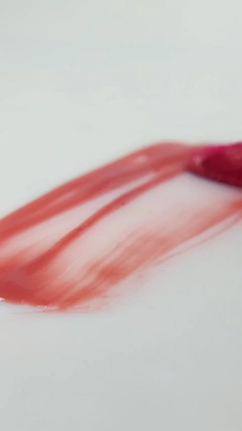 Vertical composition of a white background surface smeared with red or pink.. Stock Footage 332227175