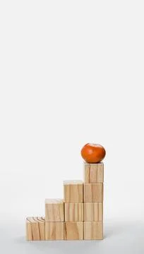 Vertical composition of wooden blocks representing growth and achievement Stock Photos