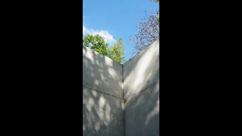 Vertical concrete wall corner with soft tree shadows moving across the surface. Stock Footage 330149752