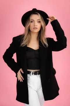Vertical confident charming seductive blond woman in hat look at camera with Stock Photos