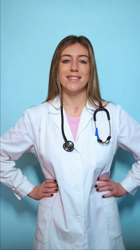 Vertical Confident female doctor posing on blue background positioning hand.. Stock Footage 297675246