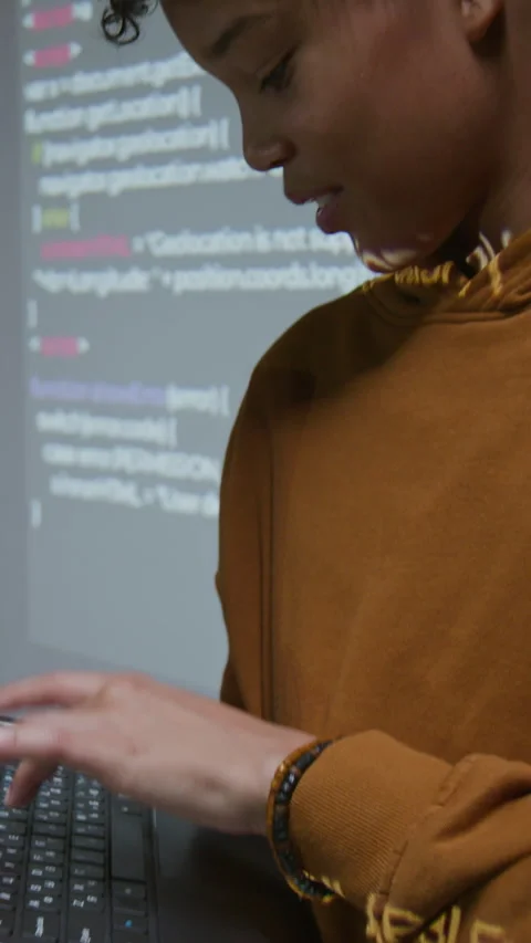 Vertical of Confident Young Black Boy Presenting Computer Code on Screen Stock Footage 318727729