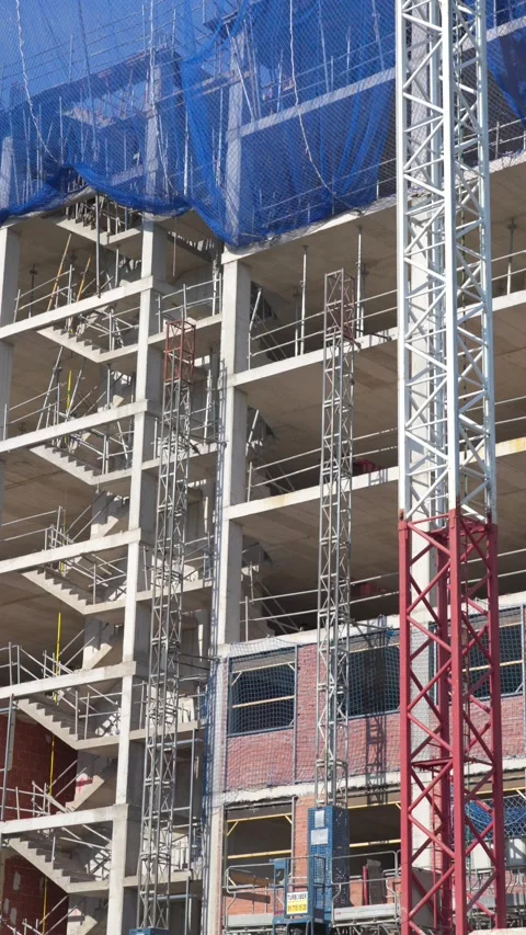 Vertical Construction Scene with Tower Crane and Concrete Residential Structure Stock-Footage 336012083