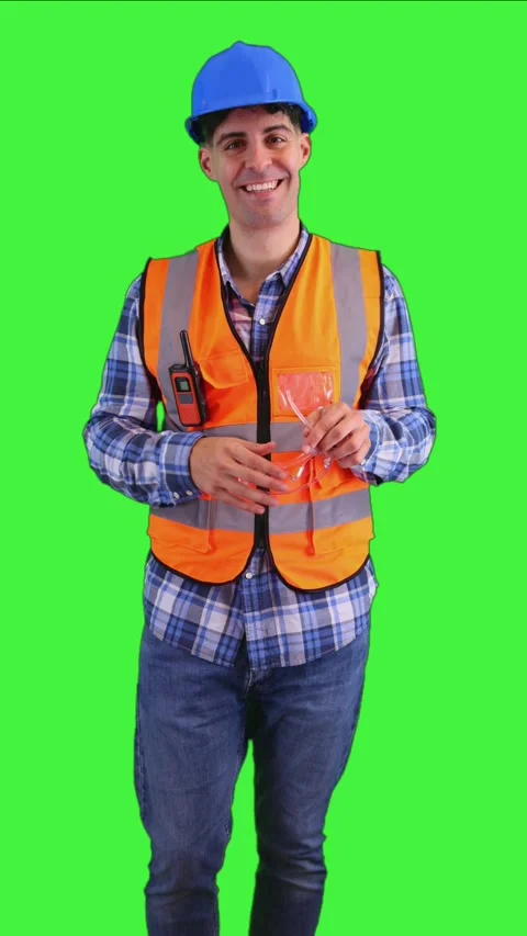 Vertical Construction worker putting on safety glasses while dressed in an .. Stock Footage 287327993