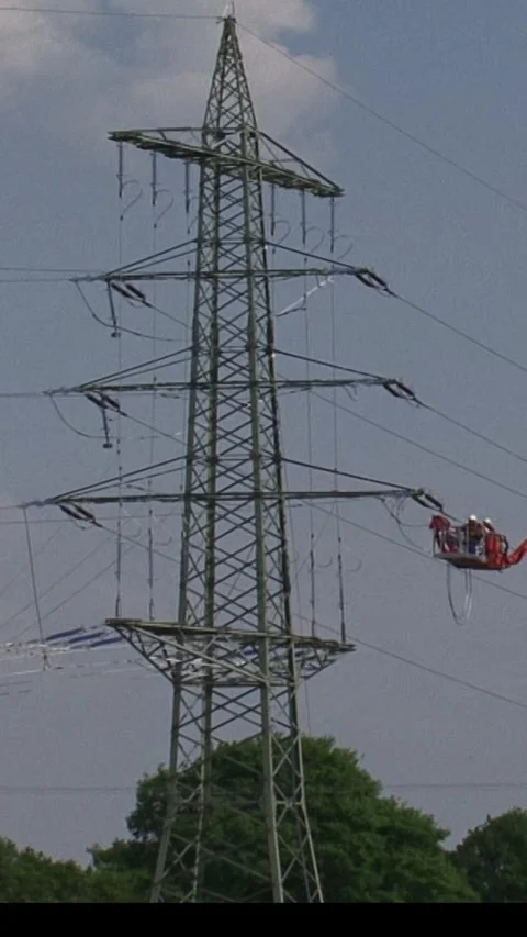 Vertical -  Construction workers on assembly platform electricity line Stock Footage 306672956