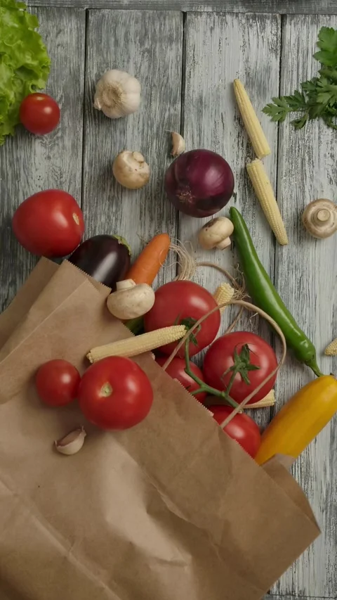 Vertical of Cooking ingredients falling on paper bag and table Stock Footage 276924504