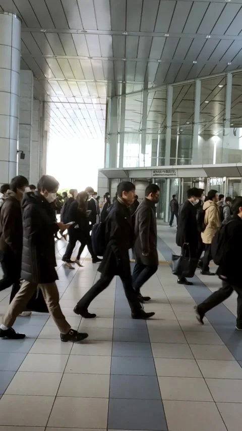 Vertical corporate crowd passing through clean interior hallway Stock Footage 312351451