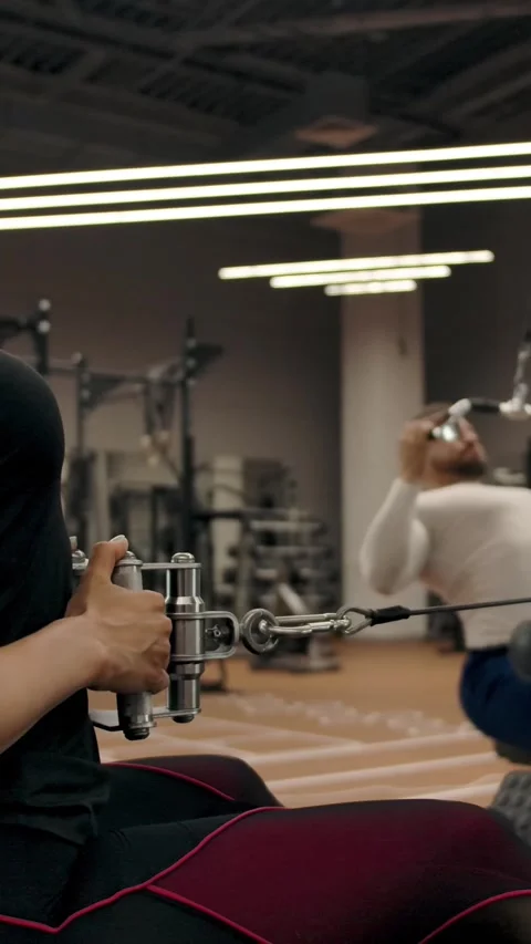 Vertical of Couple in good physical shape are doing exercises on a exercise Stock Footage 276914839