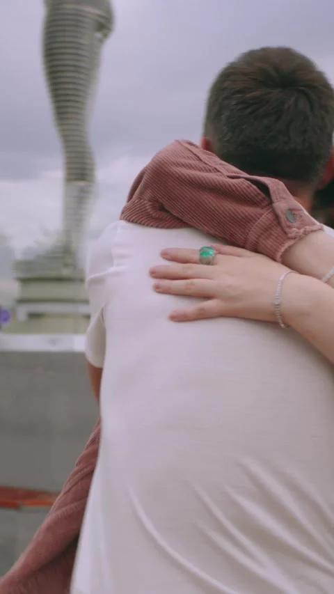 Vertical.A couple happy hug each other. outdoor,boats and statues nearby,slow Stock Footage 294068286
