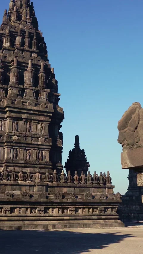 Vertical courtyard perspective features a monumental Prambanan tower beyond.. Stock Footage 341545573