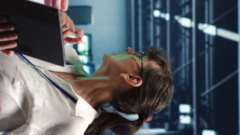 Vertical Coworkers running code in data center Stock Footage 247796861