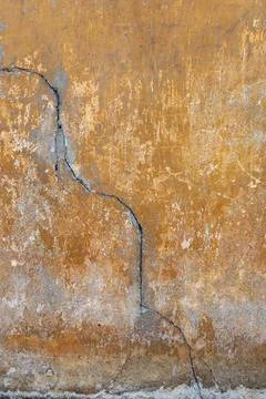 Vertical crack on aged plaster wall texture Stock Photos