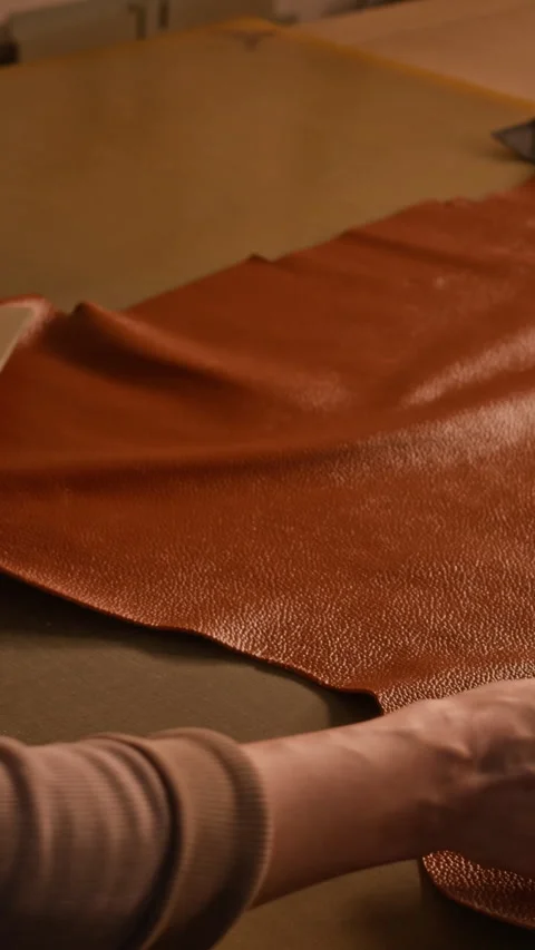 Vertical of Craftsperson Choosing Pattern for Handmade Leather Bag Stock Footage 299905119