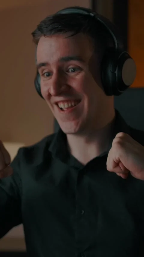 Vertical of Crazy guy dancing in headphones in cozy home interior Stock Footage 276925750