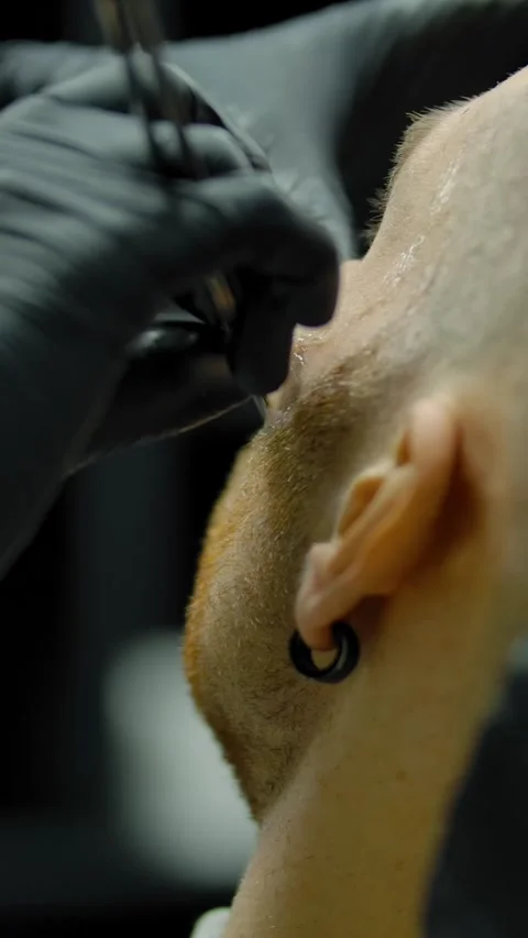 Vertical of Crop barber shaving anonymous man Stock Footage 276925660