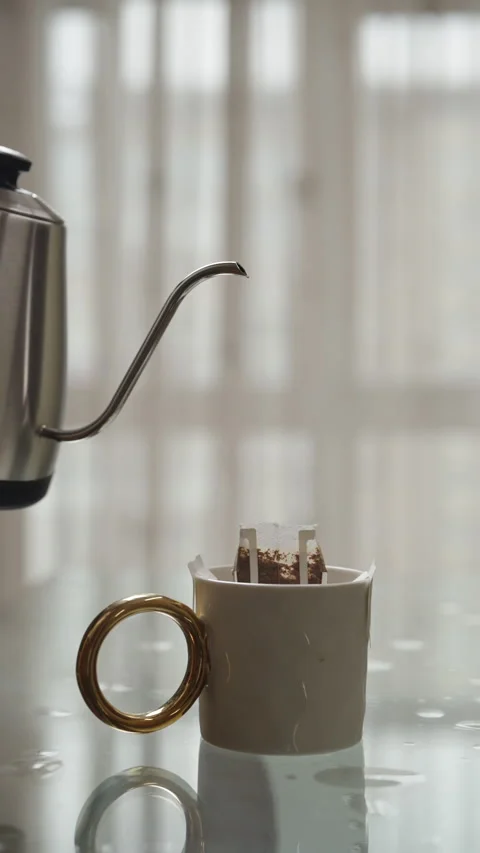 Vertical cropped shot of man pouring hot water from modern electric kettle into Stock Footage 306589532