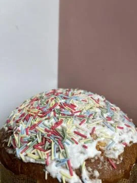 Vertical cropped shot of a paska easter cake covered with white frosting and  Stock Photos